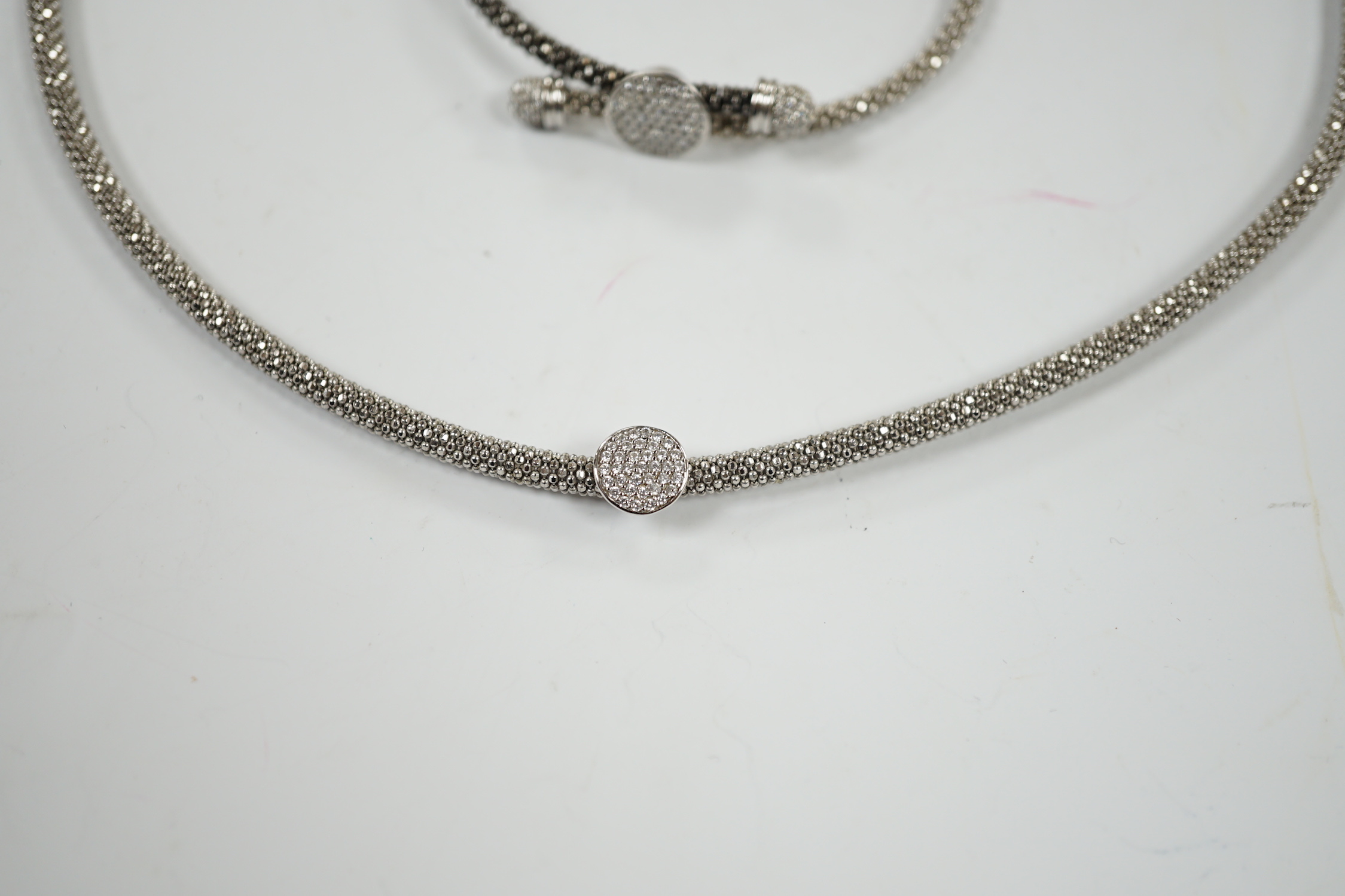 A modern Links of London, silver necklace with diamond cluster motif and a similar bracelet, in Links of London box.